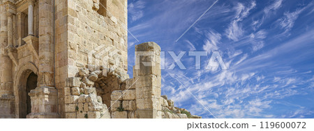 Arch of Hadrian in Gerasa (Jerash)-- was built to honor the visit of emperor Hadrian to Jerash in 129/130 AD, Jordan. Against the background of a beautiful sky with clouds Arch of Hadrian in Gerasa (Jerash)-- was built to honor the visit of emperor Hadrian to Jerash in 129/130 AD, Jordan. Against the background of a beautiful sky with clouds 119600072