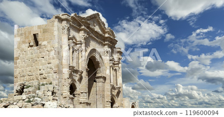 Arch of Hadrian in Gerasa (Jerash)-- was built to honor the visit of emperor Hadrian to Jerash in 129/130 AD, Jordan. Against the background of a beautiful sky with clouds Arch of Hadrian in Gerasa (Jerash)-- was built to honor the visit of emperor Hadrian to Jerash in 129/130 AD, Jordan. Against the background of a beautiful sky with clouds 119600094