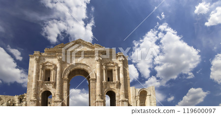 Arch of Hadrian in Gerasa (Jerash)-- was built to honor the visit of emperor Hadrian to Jerash in 129/130 AD, Jordan. Against the background of a beautiful sky with clouds Arch of Hadrian in Gerasa (Jerash)-- was built to honor the visit of emperor Hadrian to Jerash in 129/130 AD, Jordan. Against the background of a beautiful sky with clouds 119600097