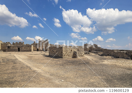 Ruins of Azraq Castle (Qasr al-Azraq) is a crusader castle (300AD),  central-eastern Jordan, 100 km east of Amman, Jordan. Against the background of a beautiful sky with clouds 119600129