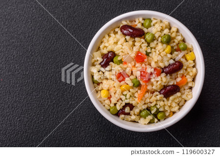 Boiled wheat bulgur porridge with vegetables peppers, peas, corn Boiled wheat bulgur porridge with vegetables peppers, peas, corn 119600327
