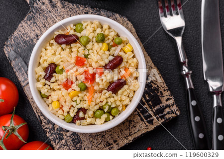 Boiled wheat bulgur porridge with vegetables peppers, peas, corn 119600329