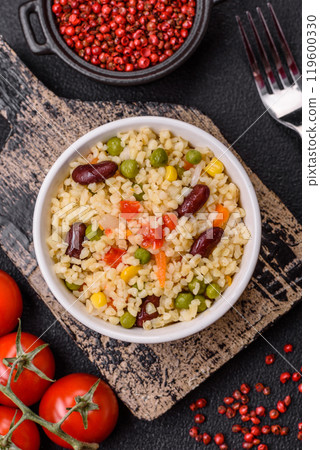 Boiled wheat bulgur porridge with vegetables peppers, peas, corn 119600330