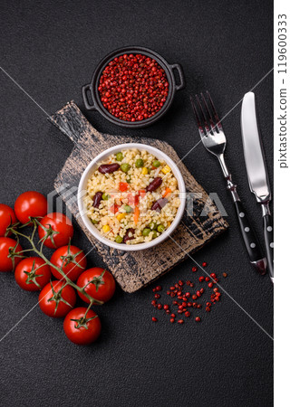 Boiled wheat bulgur porridge with vegetables peppers, peas, corn 119600333