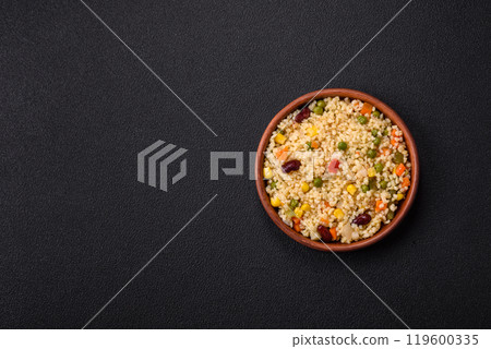 Boiled wheat bulgur porridge with vegetables peppers, peas, corn Boiled wheat bulgur porridge with vegetables peppers, peas, corn 119600335