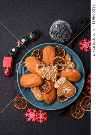 French classic madeleine sponge cake with elements of Christmas motifs French classic madeleine sponge cake with elements of Christmas motifs 119600358