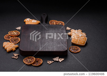 Empty wooden cutting board with copy space with gingerbread cookies and Christmas decor 119600486