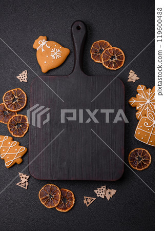 Empty wooden cutting board with copy space with gingerbread cookies and Christmas decor Empty wooden cutting board with copy space with gingerbread cookies and Christmas decor 119600488