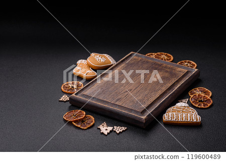 Empty wooden cutting board with copy space with gingerbread cookies and Christmas decor Empty wooden cutting board with copy space with gingerbread cookies and Christmas decor 119600489