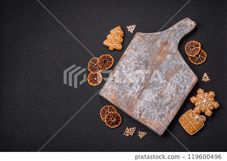 Empty wooden cutting board with copy space with gingerbread cookies and Christmas decor 119600496
