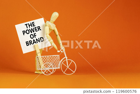 The power of brand symbol. Concept words The power of brand on beautiful white paper on clothespin. Businessman model. Beautiful orange background. Business the power of brand concept. Copy space. 119600576