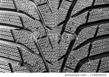 Modern winter tire tread closeup that has passed the braking test on ice Modern winter tire tread closeup that has passed the braking test on ice 119600649