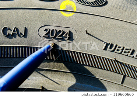 Side view of tire with designation that specify of week and year of tire production Side view of tire with designation that specify of week and year of tire production 119600660