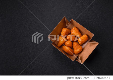 Breaded camembert or brie cheese baked in the form of nuggets with salt and spices Breaded camembert or brie cheese baked in the form of nuggets with salt and spices 119600667