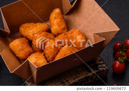Breaded camembert or brie cheese baked in the form of nuggets with salt and spices Breaded camembert or brie cheese baked in the form of nuggets with salt and spices 119600672