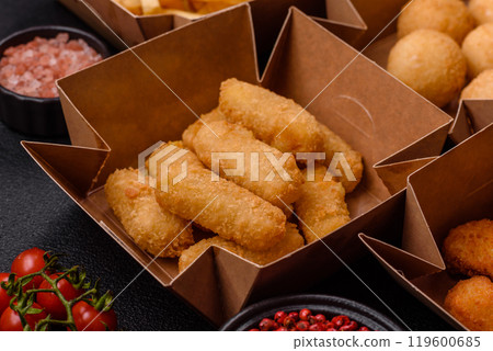 Fast food french fries, brie fries, cheese balls, cheese sticks and chicken nuggets 119600685