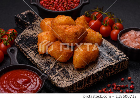 Breaded camembert or brie cheese baked in the form of nuggets with salt and spices Breaded camembert or brie cheese baked in the form of nuggets with salt and spices 119600712
