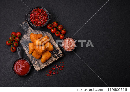 Breaded camembert or brie cheese baked in the form of nuggets with salt and spices 119600716