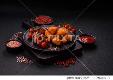 Breaded camembert or brie cheese baked in the form of nuggets with salt and spices 119600727