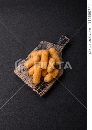 Fast food breaded cheese sticks with salt and spices 119600744