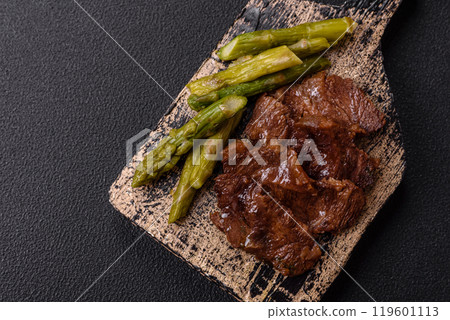 Juicy beef or pork cut into slices with boiled asparagus 119601113
