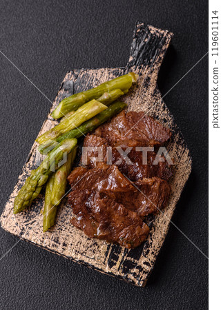 Juicy beef or pork cut into slices with boiled asparagus 119601114