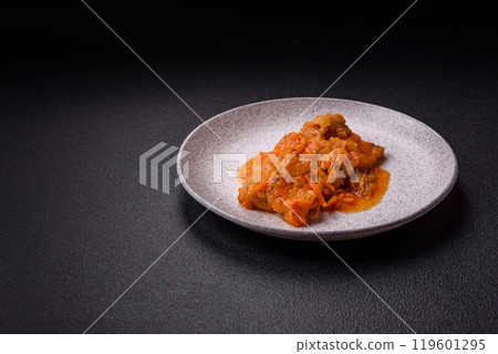 Sliced fish in tomato sauce with salt and spices 119601295