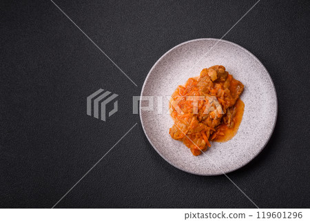 Sliced fish in tomato sauce with salt and spices 119601296