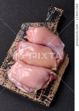 Fresh chicken fillet on a dark concrete table with spices and herbs 119601369