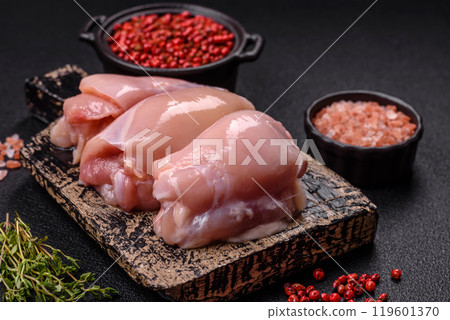 Fresh chicken fillet on a dark concrete table with spices and herbs 119601370