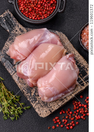 Fresh chicken fillet on a dark concrete table with spices and herbs 119601372