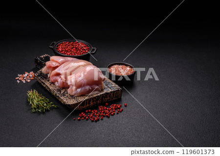 Fresh chicken fillet on a dark concrete table with spices and herbs 119601373