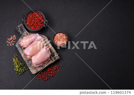 Fresh chicken fillet on a dark concrete table with spices and herbs Fresh chicken fillet on a dark concrete table with spices and herbs 119601374