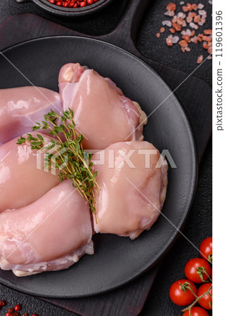 Fresh chicken fillet on a dark concrete table with spices and herbs 119601396