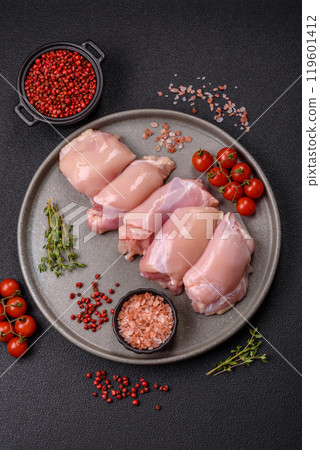 Fresh chicken fillet on a dark concrete table with spices and herbs Fresh chicken fillet on a dark concrete table with spices and herbs 119601412