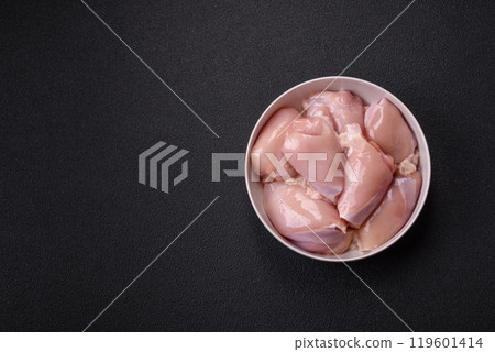 Fresh chicken fillet on a dark concrete table with spices and herbs Fresh chicken fillet on a dark concrete table with spices and herbs 119601414