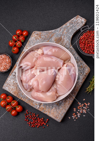 Fresh chicken fillet on a dark concrete table with spices and herbs 119601424