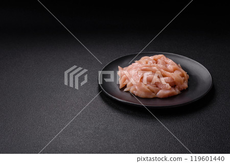 Raw chicken fillet cut into strips with spices and herbs Raw chicken fillet cut into strips with spices and herbs 119601440