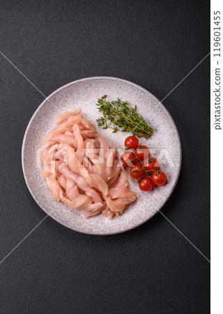 Raw chicken fillet cut into strips with spices and herbs Raw chicken fillet cut into strips with spices and herbs 119601455