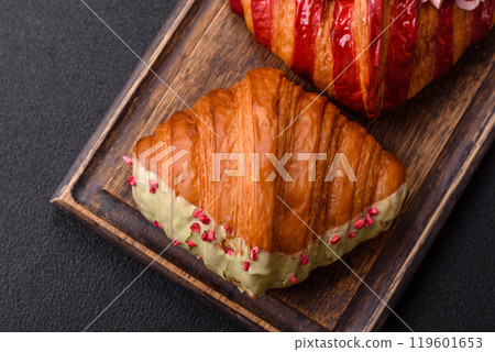 Crispy sweet red croissant with pistachio, raspberry and strawberry 119601653