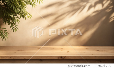 Beautiful background with wooden table and foliage shadow on wall 119601709