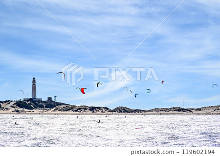 Los Canos de Meca, Barbate, Cadiz; August 19, 2022: athletes practicing kitesurfing in front of the beach of the Trafalgar Lighthouse Los Canos de Meca, Barbate, Cadiz; August 19, 2022: athletes practicing kitesurfing in front of the beach of the Trafalgar Lighthouse 119602194