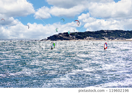Los Canos de Meca, Barbate, Cadiz; August 19, 2022: athletes practicing kitesurfing in front of the beach of the Trafalgar Lighthouse Los Canos de Meca, Barbate, Cadiz; August 19, 2022: athletes practicing kitesurfing in front of the beach of the Trafalgar Lighthouse 119602196