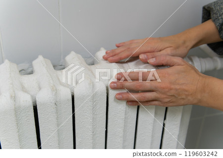 hands metal home warm white iron radiator heater domestic house interior equipment battery 119603242