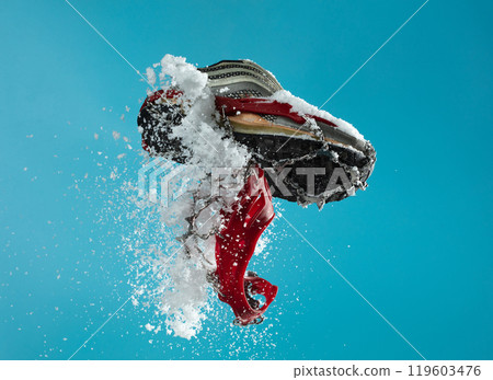 Hiking trail in winter should wear Crampons snow spike on shoes to protect slippery on ice icy surface road. Crampon spike shoe walk good on snow, blue sky background isolated Hiking trail in winter should wear Crampons snow spike on shoes to protect slippery on ice icy surface road. Crampon spike shoe walk good on snow, blue sky background isolated 119603476