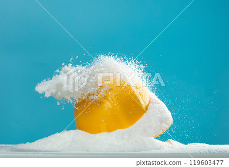 White Snow fall on yellow safety hard hat of engineer over blue sky background isolated. Yellow hard hat helmet was covered by snow storm accident hit 119603477