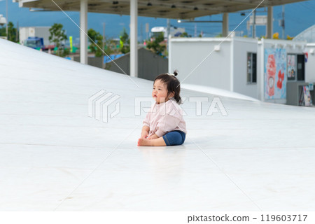 [Infants sitting on giant playground equipment] 119603717