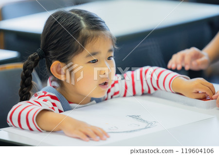 Elementary school students taking lessons in a classroom Elementary school students taking lessons in a classroom 119604106