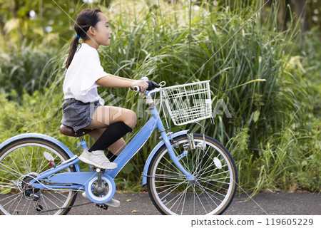 A girl riding a bicycle A girl riding a bicycle 119605229