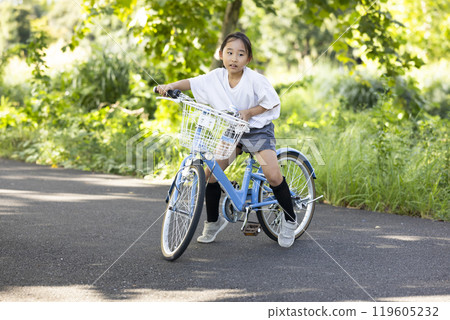 A girl riding a bicycle 119605232